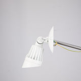 White single-head LED security light on a round mounting plate, head angled down